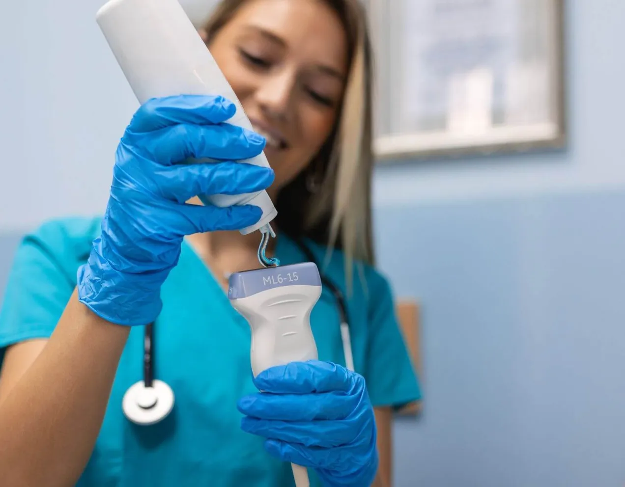 Sonographer applying gel to ultrasound transducer before performing a sonography exam