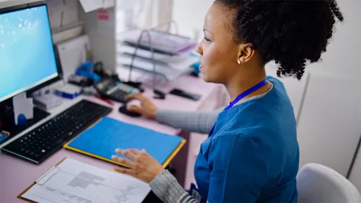 A medical assistant works to file medical records