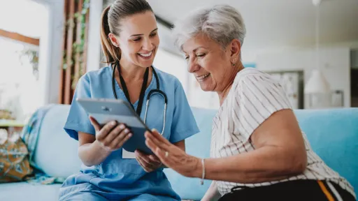 LPN using digital tablet with patient.