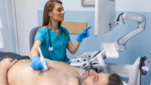 Echocardiographer exams male adult.