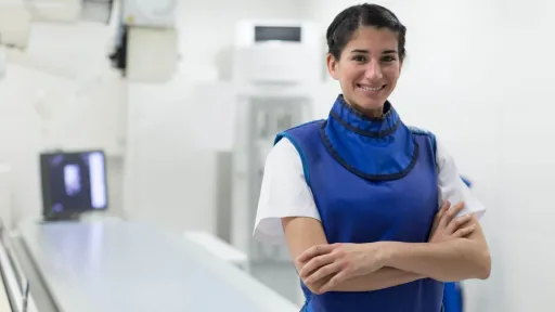 Radiology tech wearing lead apron.