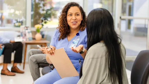 Medical office administrator talking with a patient during the intake process