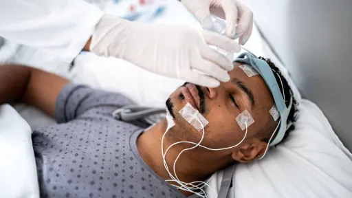 Polysomnographer monitors patient during a sleep study, showing the real-world demands and rewards of the career path