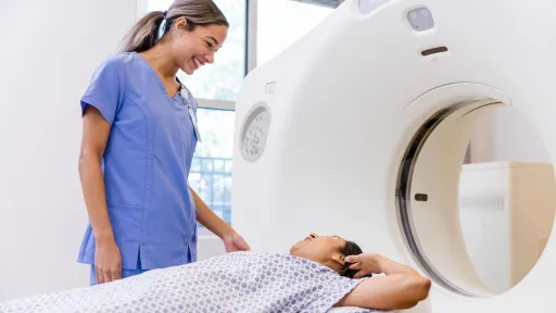 Radiologic technologist assisting a patient during a CT scan, representing careers in diagnostic imaging.