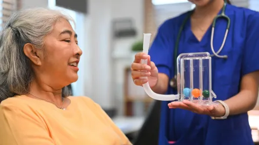 Respiratory therapist teaches patient how to use an incentive spirometer highlighting a quality they need for success