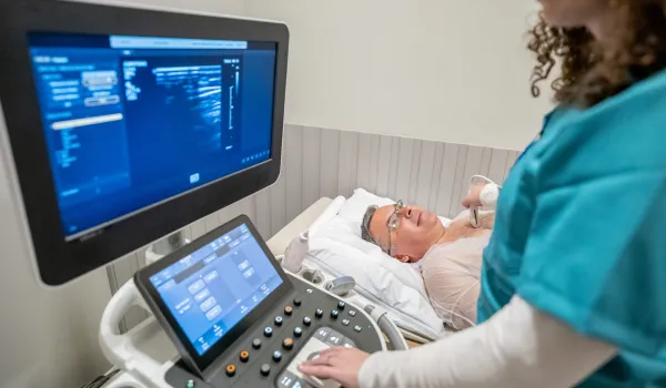 An elderly patient undergoes a contrast-enhanced ultrasound to detect potentially diseased areas of tissue.