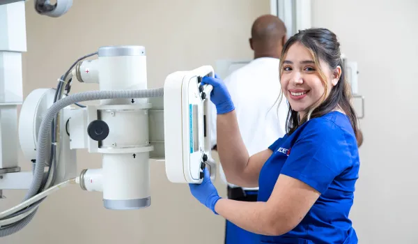 Radiologic Tech demonstrating skills at x-ray machine.