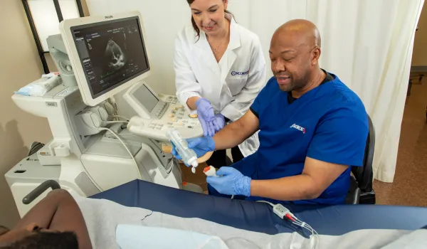 Echocardiographers prepare instrument for patient exam.