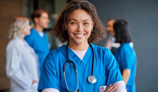 Registered nurse with BSN smiling confidently, representing leadership and patient care in clinical nursing environments.