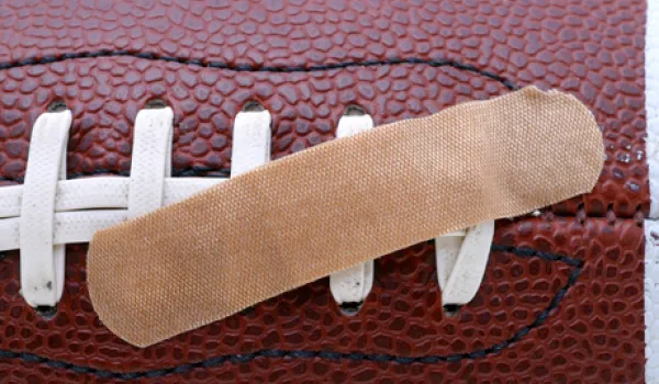 Physical therapists help rehabilitate football players who have sustained injury.