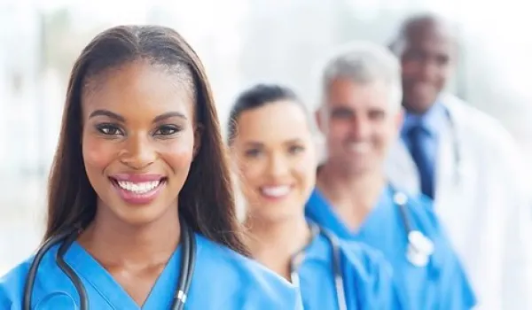 Nurses standing in front of a doctor