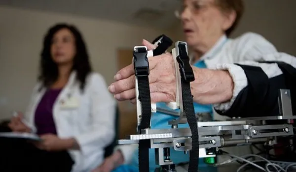 Occupational Therapist helping patient with hand