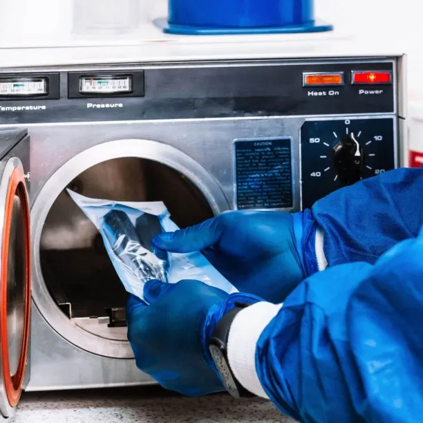 Sterile processing technician loading instruments into autoclave, demonstrating key skills learned in technician training.