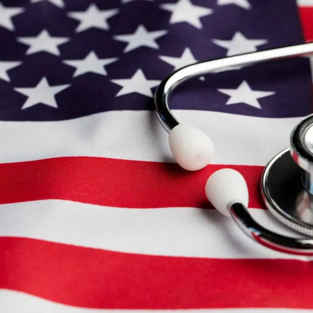 A medical stethoscope rests on top of a draped United States flag, symbolizing the career path transition from a military medic to a registered nurse.