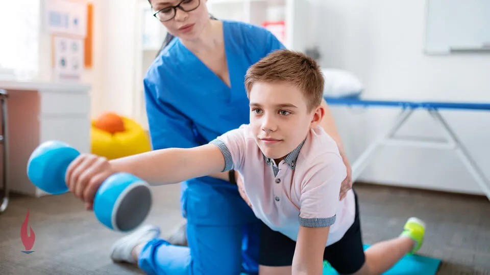 Occupational therapy assistant working with boy Occupational therapy assistant working with boy