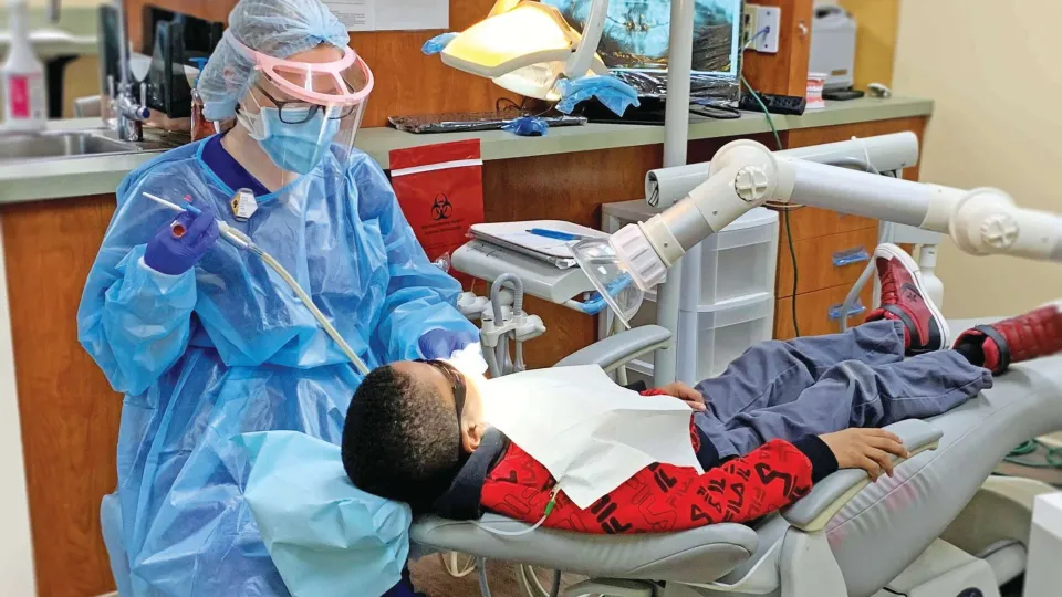 Concorde graduate performs pediatric dental cleaning during community event. Concorde graduate performs pediatric dental cleaning during community event.