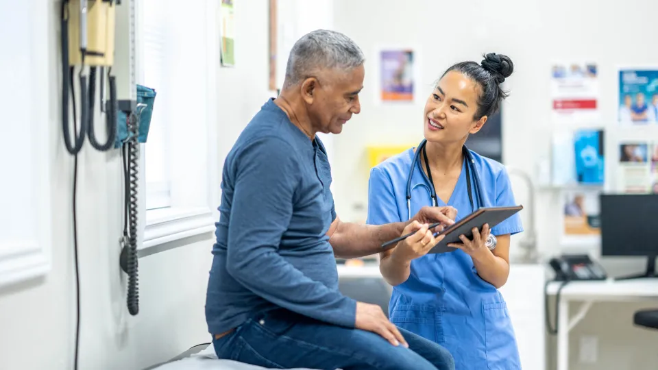 A nurse communicates with patient using a translation app. A nurse communicates with patient using a translation app.