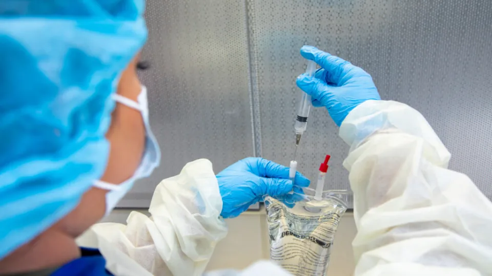 Pharmacy technician preparing medication with syringe and IV bag in sterile environment, showcasing certification skills. Pharmacy technician preparing medication with syringe and IV bag in sterile environment, showcasing certification skills.