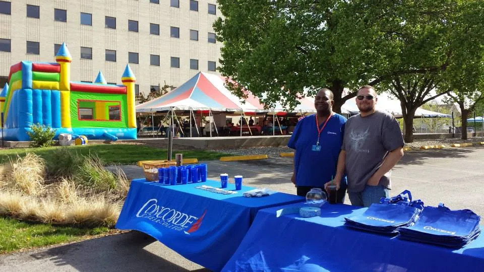 Concorde students in Kansas City greet visitors at a community health fair.