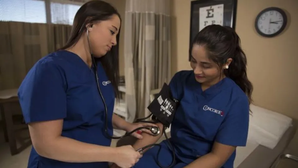 Nurse checking blood pressure Nurse checking blood pressure