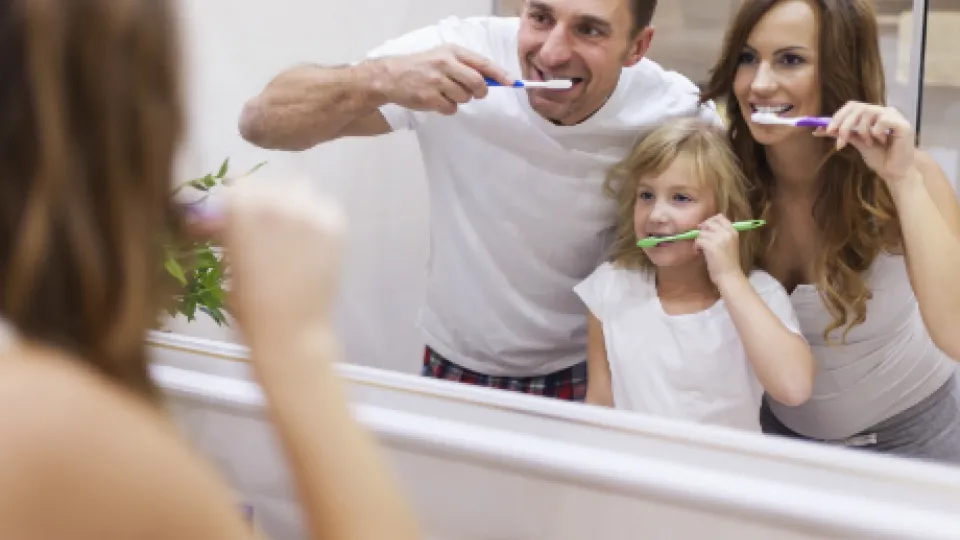 family brushing teeth
