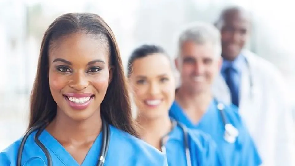 Nurses standing in front of a doctor