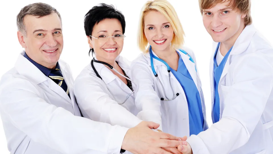 unity of four happy successful doctors health care career