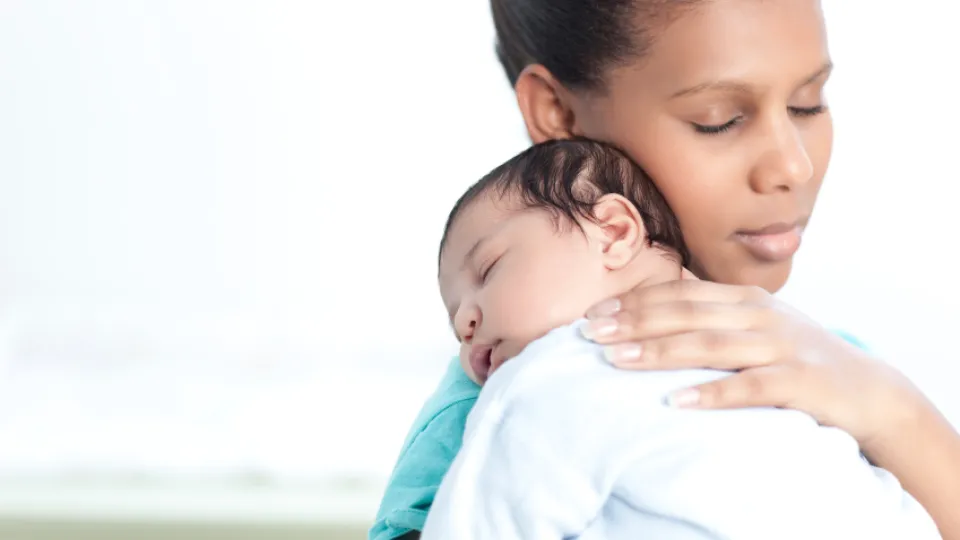 Mom relaxing newborn