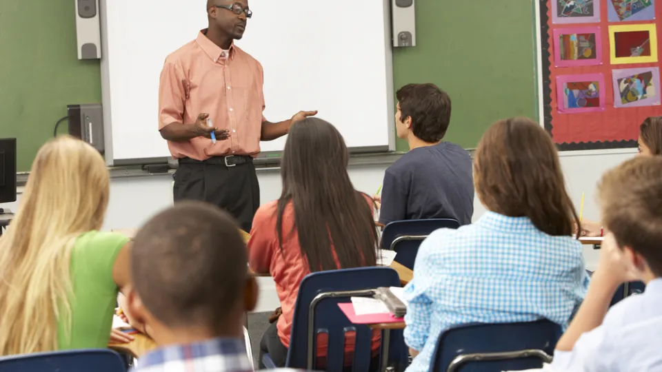 Teacher Using Interactive Whiteboard During Lesson health care interview