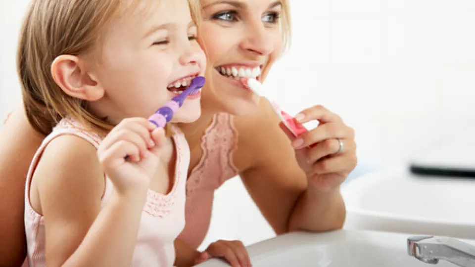Mom and child brushing teeth