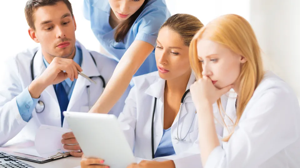 Nursing team gathers around tablet integrating into existing health care team